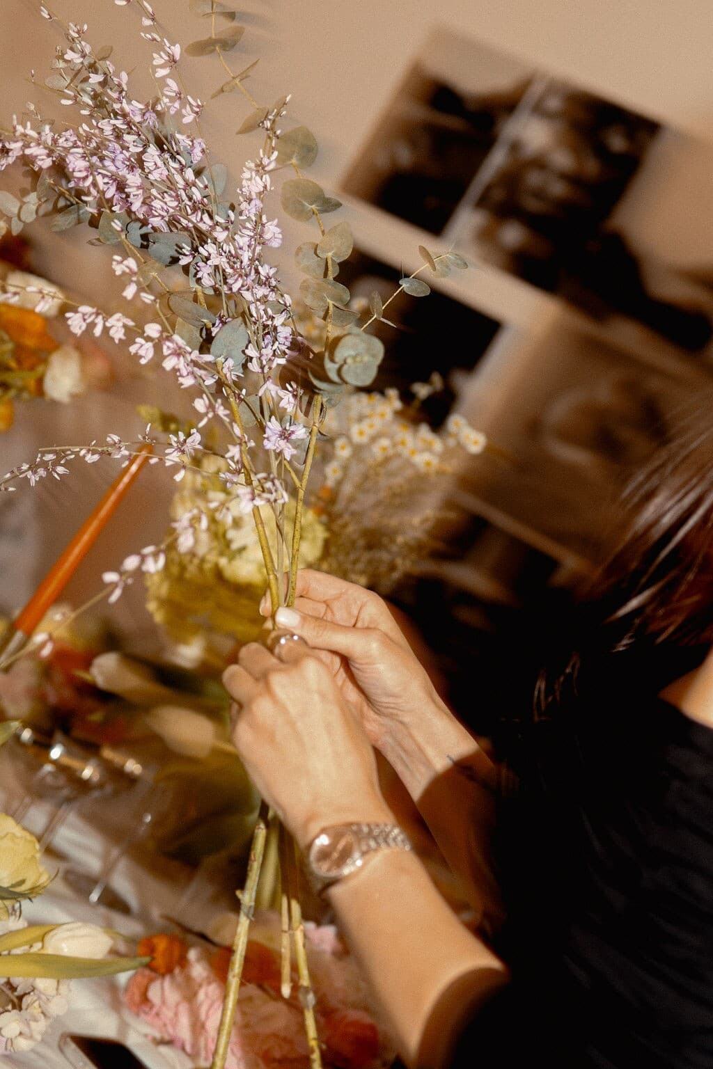 Participant arranging stems during the March 2026 floral workshop