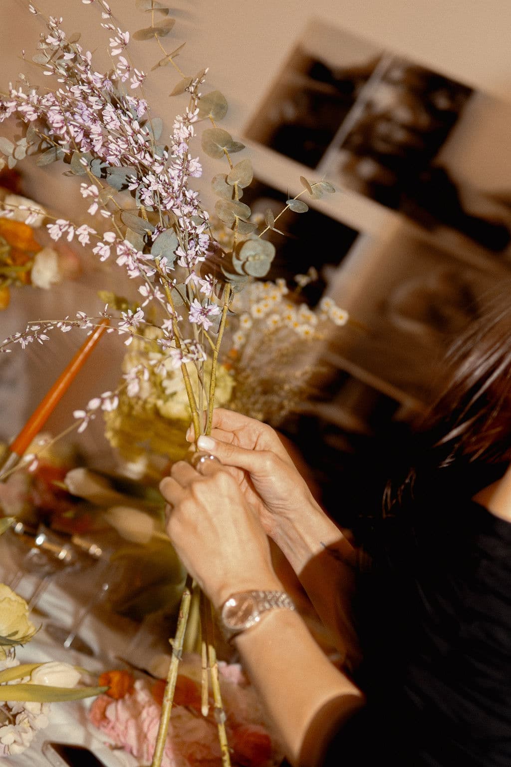 Participant arranging stems during the March 2026 floral workshop