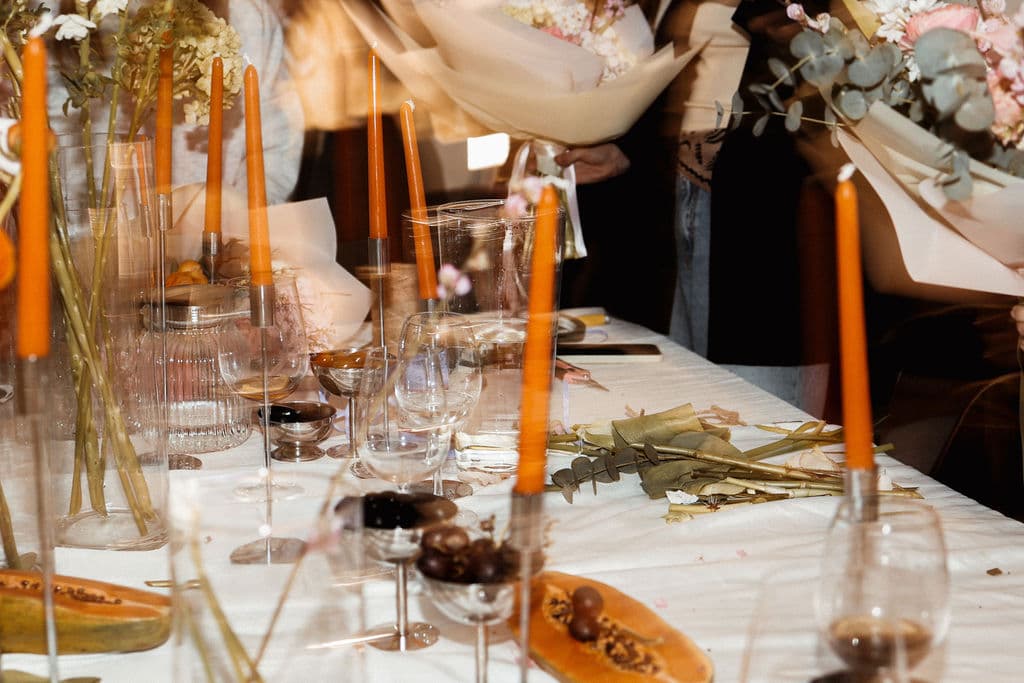 Guests gathered around the floral workshop table at Sobolieva Brow Bar in Lisbon